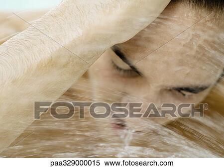 Man's face leaning into water spray View Large Photo Image Stock Photography - Man's face leaning into water spray. Fotosearch