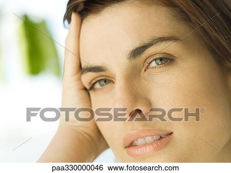 Stock Photograph - Woman leaning head on hand, close-up. Fotosearch