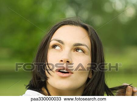 Stock Image - Woman looking up with mouth open. Fotosearch