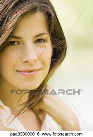 Stock Photograph - Woman smiling while hair blows in the wind. Fotosearch
