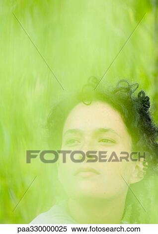 Woman's face, green blur in foreground View Large Photo Image Stock Photography - Woman's face, green blur in foreground. Fotosearch