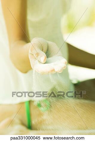 Sand blowing out of woman's hand View Large Photo Image Stock Photography - Sand blowing out of woman's hand. Fotosearch