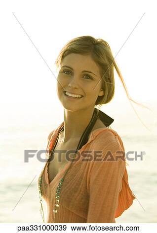 Woman smiling, sea in background View Large Photo Image Stock Photo - Woman smiling, sea in background. Fotosearch