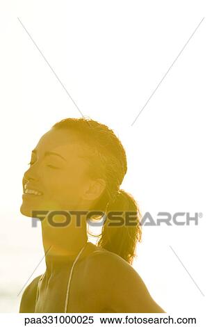 Stock Photography - Woman smiling with eyes closed. Fotosearch