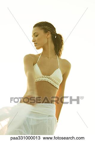 Stock Image - Woman wearing bikini top and skirt. Fotosearch