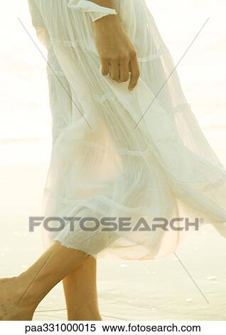 Stock Photography - Woman wearing translucent skirt, low section. Fotosearch