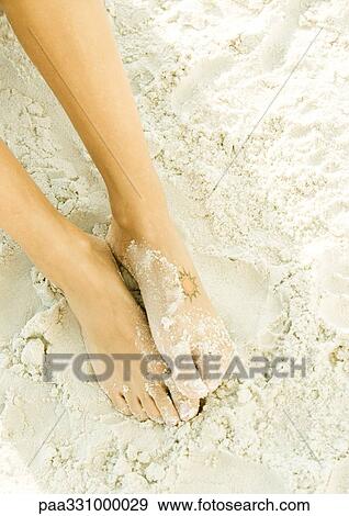 Stock Photo - Woman's feet in sand. Fotosearch