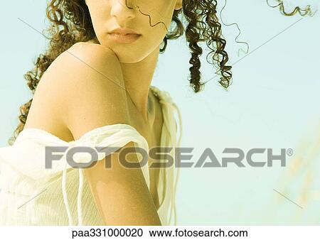 Stock Image - Woman's strap falling off shoulder, cropped. Fotosearch