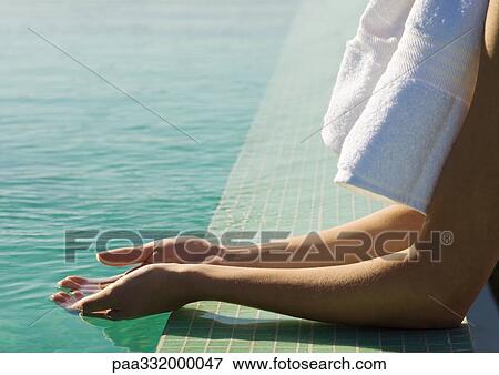 Stock Photo - Hands cupping water at edge of pool. Fotosearch