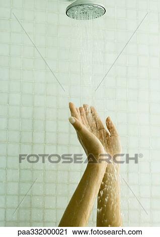 Woman holding up hands under shower View Large Photo Image Stock Image - Woman holding up hands under shower. Fotosearch