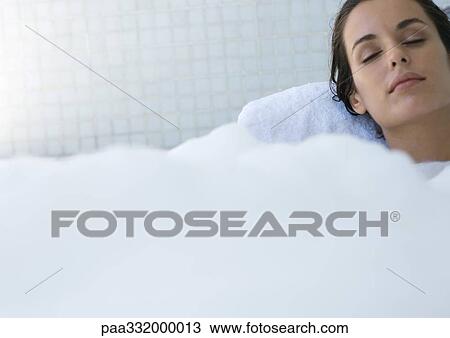 Stock Image - Woman in bubble bath. Fotosearch