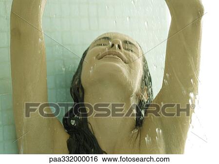 Woman in shower with arms up and head back View Large Photo Image Stock Photograph - Woman in shower with arms up and head back. Fotosearch