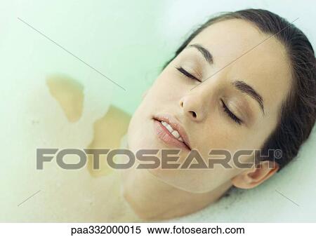 Woman reclining in bath, eyes closed View Large Photo Image Stock Photography - Woman reclining in bath, eyes closed. Fotosearch