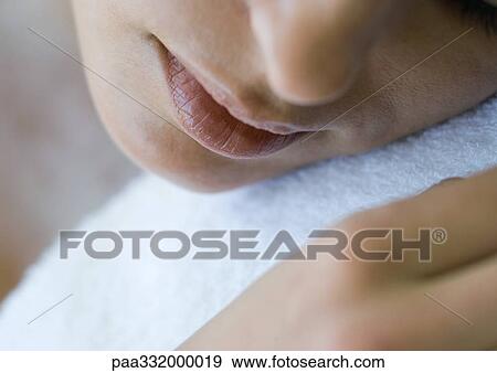 Woman's face against white towel View Large Photo Image Stock Photo - Woman's face against white towel. Fotosearch