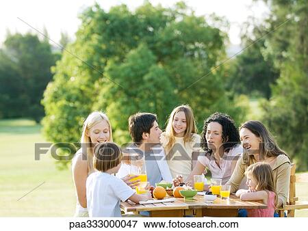 Stock Photo - Extended family having picnic. Fotosearch