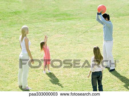 Family playing ball outdoors View Large Photo Image Stock Image - Family playing ball outdoors. Fotosearch