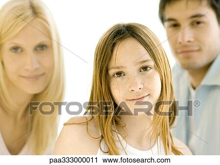 Stock Image - Girl in front of parents, portrait. Fotosearch