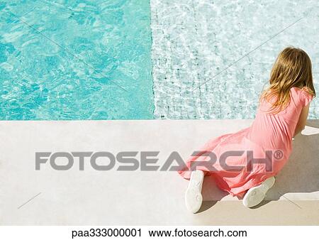 Girl kneeling by edge of pool, high angle view View Large Photo Image Stock Image - Girl kneeling by edge of pool, high angle view. Fotosearch
