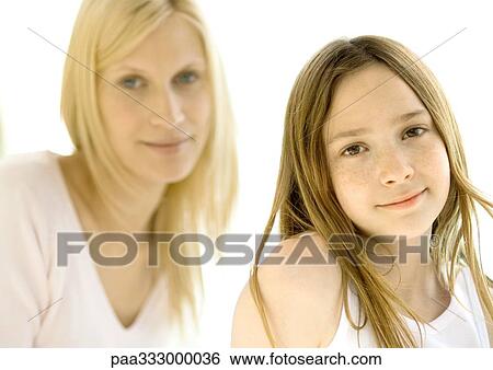Stock Photograph - Girl, mother in background. Fotosearch