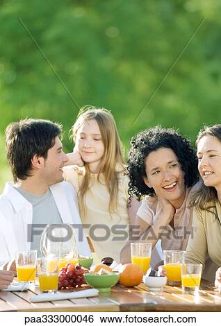 Stock Photograph - Having breakfast outdoors. Fotosearch
