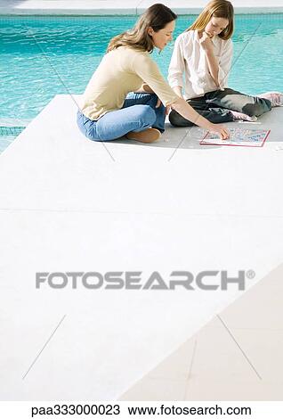 Mother and daughter sitting by edge of pool, playing board game View Large Photo Image Stock Image - Mother and daughter sitting by edge of pool, playing board game. Fotosearch