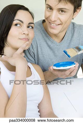 Stock Photo - Couple deciding on paint color. Fotosearch