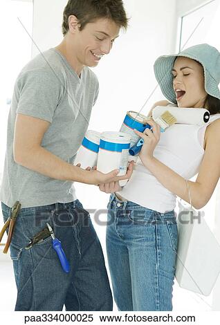 Couple holding painting supplies View Large Photo Image Stock Photography - Couple holding painting supplies. Fotosearch
