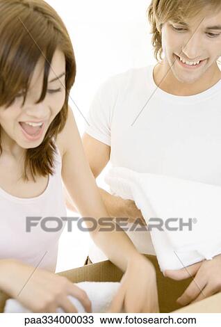 Couple unpacking box View Large Photo Image Stock Image - Couple unpacking box. Fotosearch