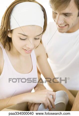 Stock Image - Couple unpacking box. Fotosearch