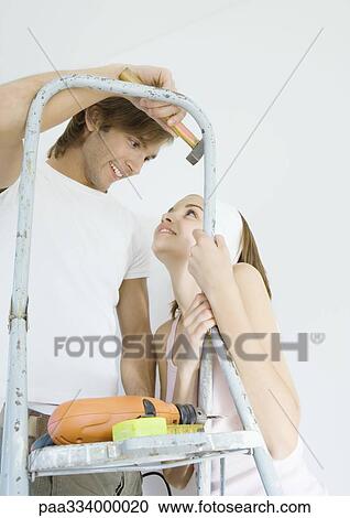 Couple with ladder and tools, smiling View Large Photo Image Stock Image - Couple with ladder and tools, smiling. Fotosearch
