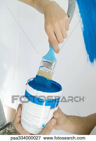 Stock Photo - Couple with paint can and paint brush. Fotosearch