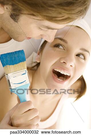 Stock Image - Couple with paintbrush. Fotosearch