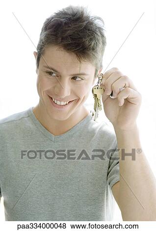 Man holding up keys View Large Photo Image Stock Photo - Man holding up keys. Fotosearch