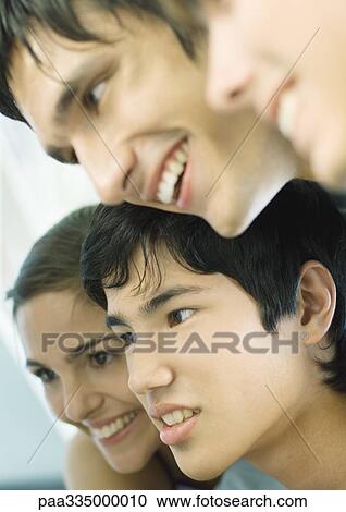 Stock Image - Four young adult faces. Fotosearch