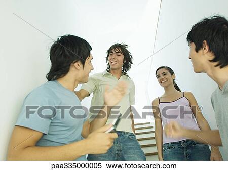 Stock Photography - Four young friends meeting in stairway. Fotosearch