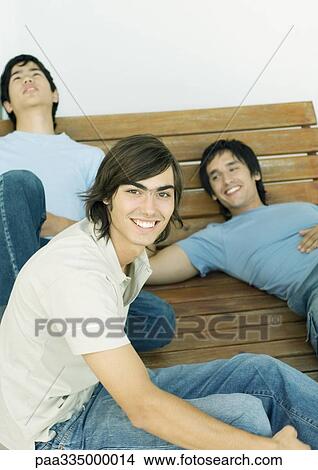 Picture - Group of young men hanging out together. Fotosearch