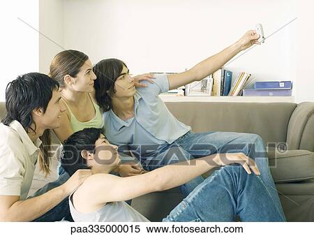Stock Photography - Taking group photo with cell phone. Fotosearch
