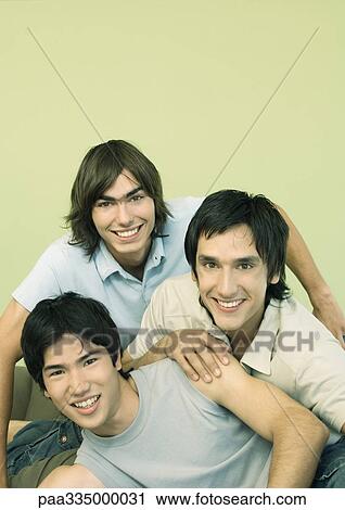 Three young male friends smiling, portrait View Large Photo Image Stock Image - Three young male friends smiling, portrait. Fotosearch