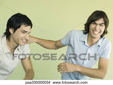 Two young men laughing View Large Photo Image Picture - Two young men laughing. Fotosearch