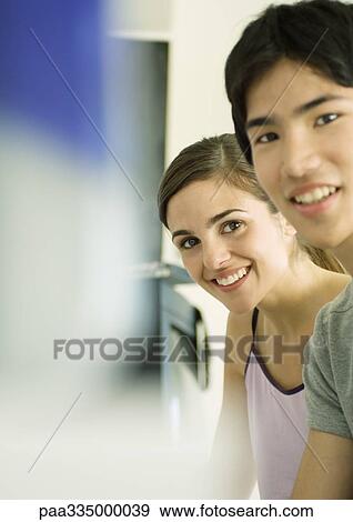 Young couple smiling View Large Photo Image Stock Photo - Young couple smiling. Fotosearch