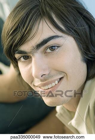 Young man smiling, portrait View Large Photo Image Stock Photo - Young man smiling, portrait. Fotosearch