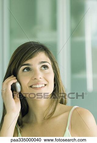Young woman using cell phone View Large Photo Image Stock Image - Young woman using cell phone. Fotosearch
