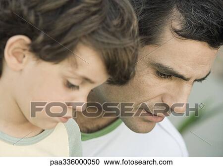 Father and son side by side and looking down together, side view, portrait, close-up View Large Photo Image Stock Image - Father and son side by side and looking down together, side view, portrait, close-up. Fotosearch