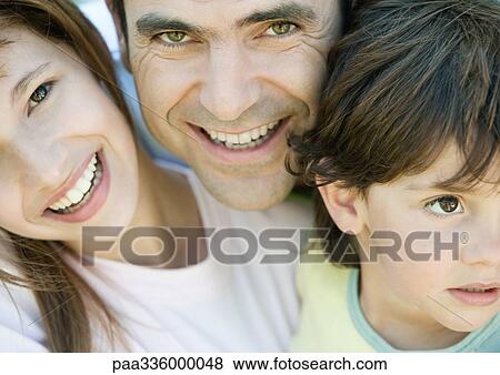 Father with two children, boy looking away, father and daughter smiling and looking at camera, portrait, close-up View Large Photo Image Stock Photo - Father with two children, boy looking away, father and daughter smiling and looking at camera, portrait, close-up. Fotosearch