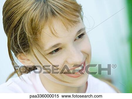 Girl smiling and looking away, portrait, close-up View Large Photo Image Stock Photography - Girl smiling and looking away, portrait, close-up. Fotosearch