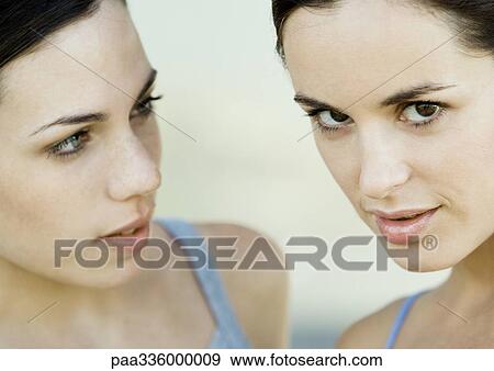 Stock Photo - Young woman loooking at her friend. Fotosearch