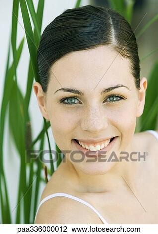 Young woman smiling, portrait, front view, close-up View Large Photo Image Stock Image - Young woman smiling, portrait, front view, close-up. Fotosearch