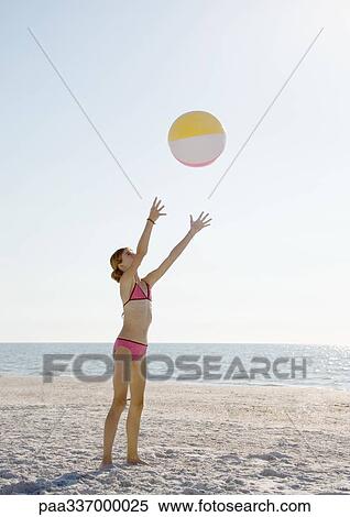 Girl catching beach ball on beach View Large Photo Image Stock Photography - Girl catching beach ball on beach. Fotosearch