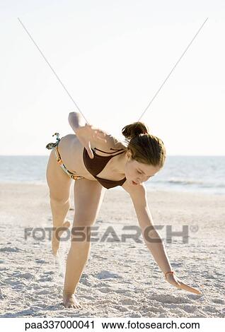 Girl starting cartwheel on beach View Large Photo Image Stock Image - Girl starting cartwheel on beach. Fotosearch