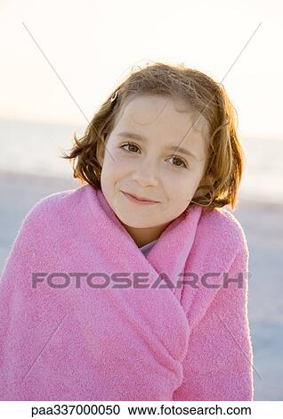 Girl wrapped in towel on beach, portrait View Large Photo Image Stock Image - Girl wrapped in towel on beach, portrait. Fotosearch